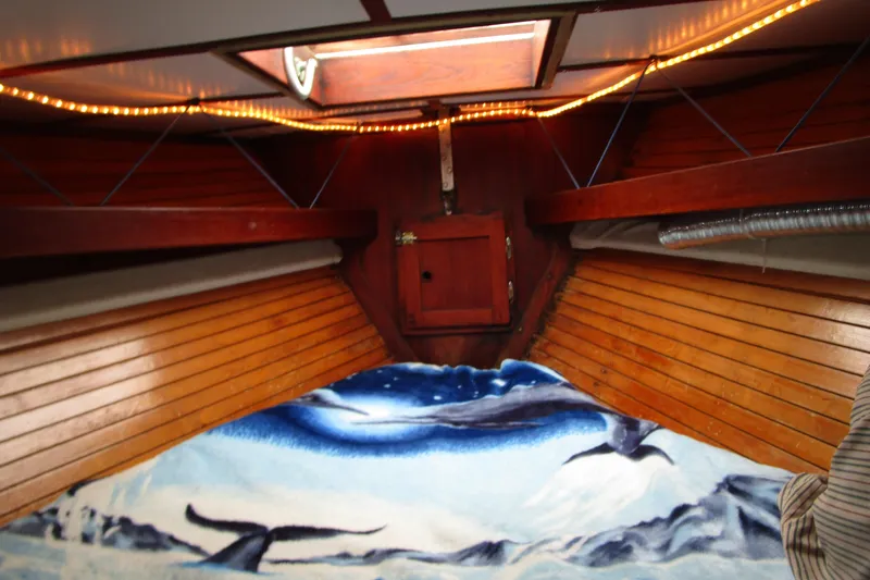 Slide: The Image of Interior of a 1977 Valiant 40 sailboat with wooden paneling and marine-themed decor. - 17