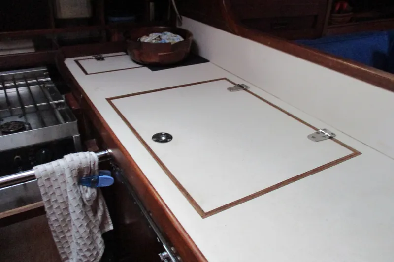 Slide: The Image of 1977 Valiant 40 yacht galley with stove, countertop, and storage compartments. - 25