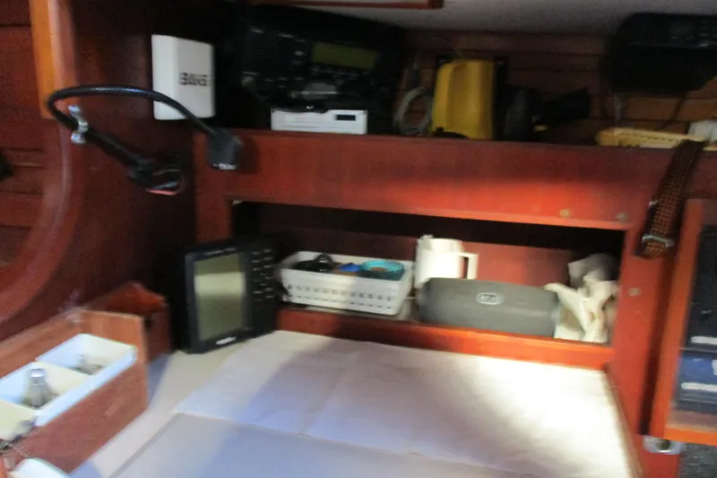 Slide: The Image of Interior of a 1977 Valiant 40 sailboat with navigation equipment and storage shelves. - 30