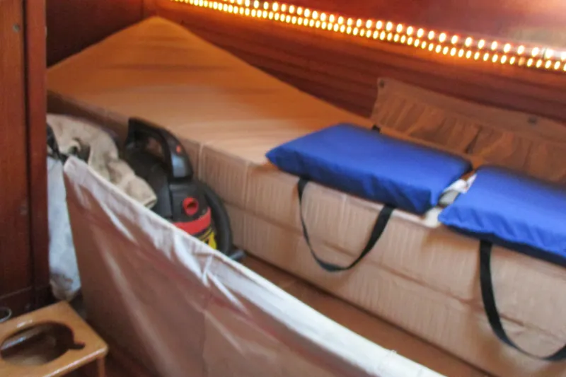 Slide: The Image of 1977 Valiant 40 yacht interior with bed, cushions, and vacuum cleaner aft port sleeping. - 36