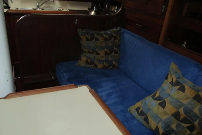 Slide: The Image of Interior of 1977 Valiant 40 sailboat with blue seating and patterned cushions. - 39