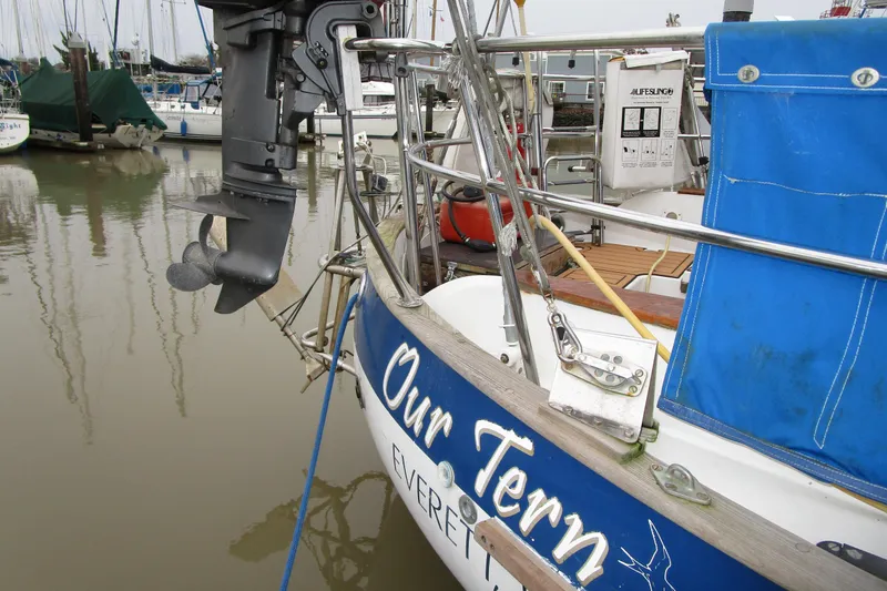 Slide: The Image of 1977 Valiant 40 sailboat stern with motor, docked in marina. - 5