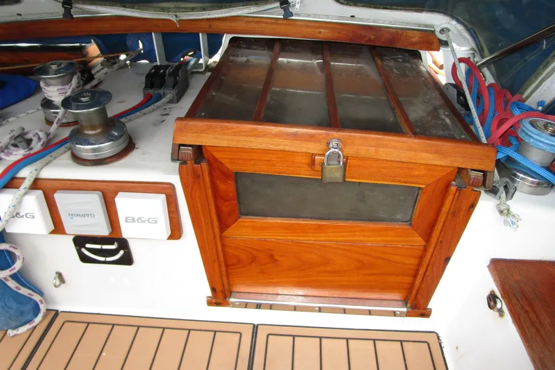 Slide: The Image of 1977 Valiant 40 sailboat cockpit with wooden hatch, winches, and navigation equipment. - 9