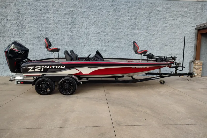 The Image of 2016 Nitro Z21 boat with dual seats and powerful engine on trailer. - 1