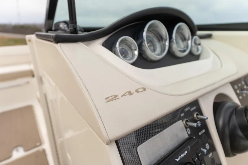 Slide: The Image of Dashboard of a 2014 Sea Ray 240 Sundeck Outboard boat with gauges and controls. - 12