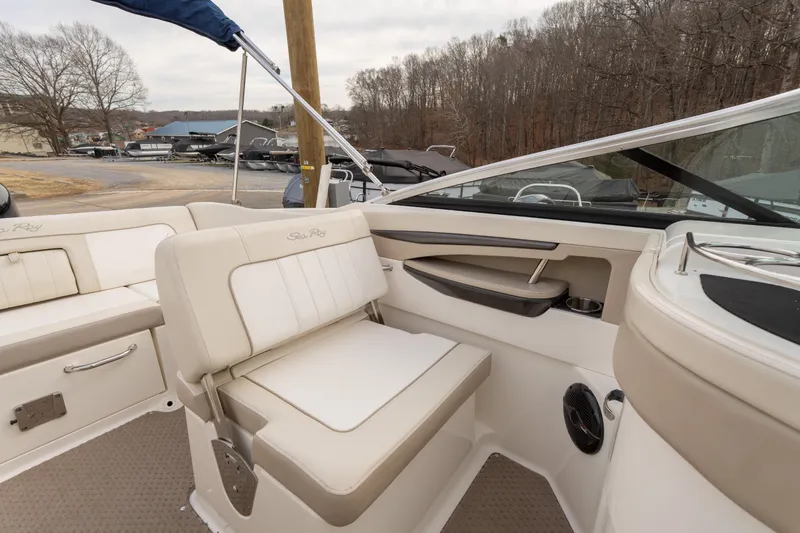 Slide: The Image of 2014 Sea Ray 240 Sundeck Outboard interior with beige seating and modern design. - 14