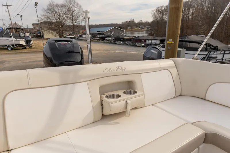 Slide: The Image of 2014 Sea Ray 240 Sundeck Outboard interior with cup holders and seating. - 20