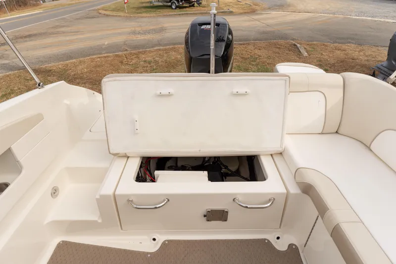 Slide: The Image of 2014 Sea Ray 240 Sundeck Outboard boat interior with open storage compartment. - 21