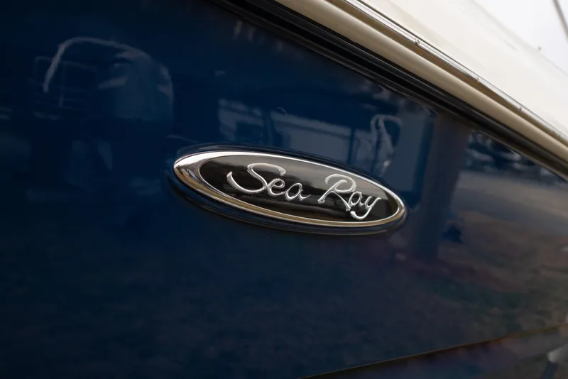 Slide: The Image of 2014 Sea Ray 240 Sundeck Outboard logo on blue boat exterior. - 4