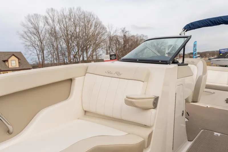Slide: The Image of 2014 Sea Ray 240 Sundeck Outboard boat interior with beige seating and windshield. - 6