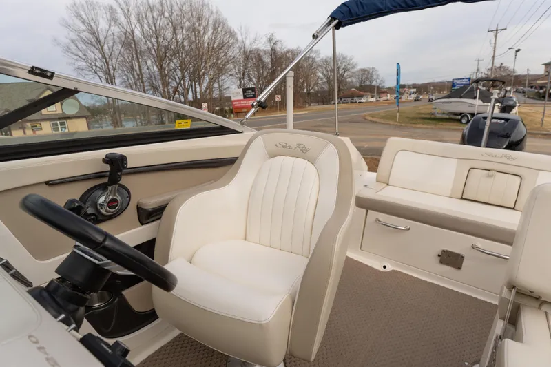 Slide: The Image of 2014 Sea Ray 240 Sundeck Outboard interior with steering wheel and seating. - 9