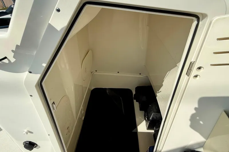 Slide: The Image of 2017 Boston Whaler 210 Montauk storage compartment, open and empty, with visible interior details. - 14