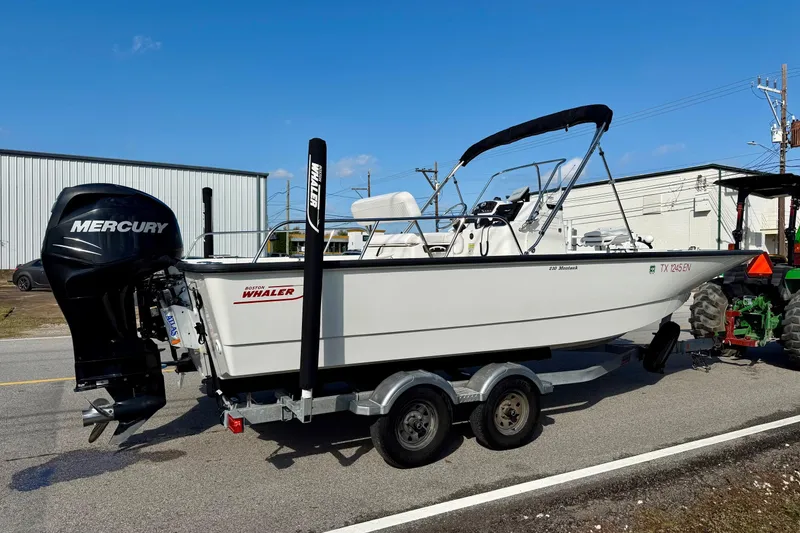 Slide: The Image of 2017 Boston Whaler 210 Montauk boat on trailer with Mercury outboard motor. - 4