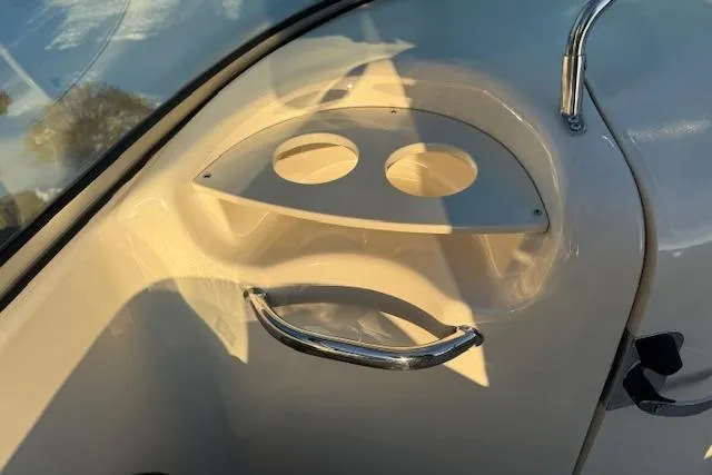 Slide: The Image of 2005 Sea Ray 220 Sundeck boat interior with cup holders and chrome handle. - 11