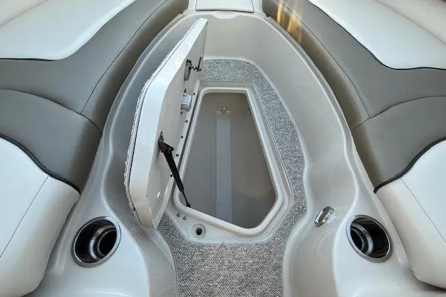 Slide: The Image of Interior of a 2005 Sea Ray 220 Sundeck with open storage compartment. - 16