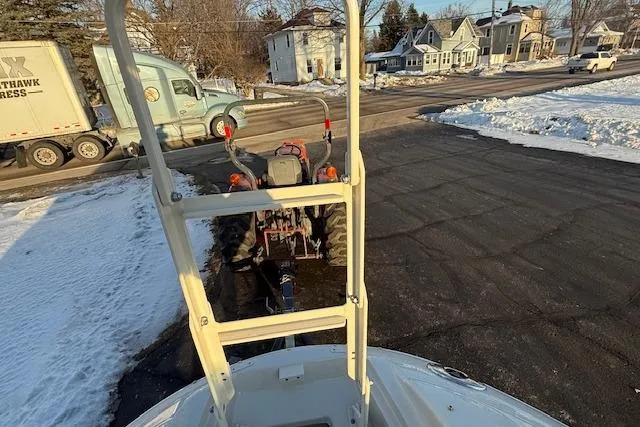 Slide: The Image of 2005 Sea Ray 220 Sundeck on snowy driveway with tractor and truck nearby. - 21