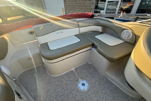 Slide: The Image of 2005 Sea Ray 220 Sundeck interior with cushioned seating and carpeted floor. - 24