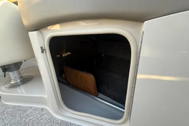 Slide: The Image of Open storage compartment in 2005 Sea Ray 220 Sundeck boat. - 26