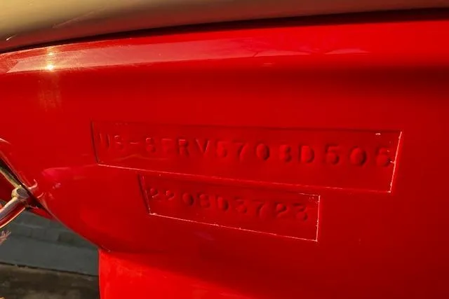 Slide: The Image of Close-up of a 2005 Sea Ray 220 Sundeck hull identification number on a red surface. - 37