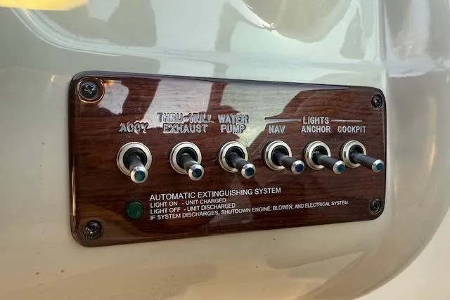 Slide: The Image of Control panel of a 2005 Sea Ray 220 Sundeck boat with labeled switches. - 9