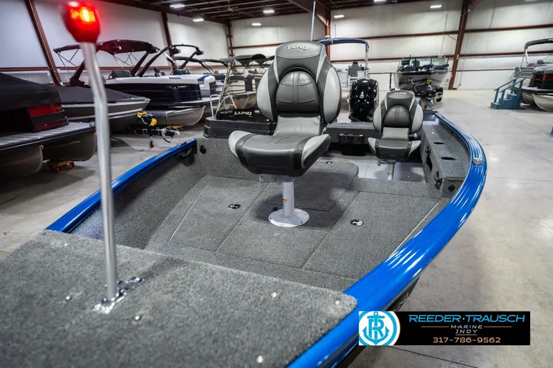 Slide: The Image of 2026 Lund 1675 Adventure SS boat interior with seating, displayed in a showroom. - 10