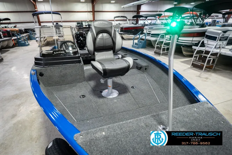 Slide: The Image of 2026 Lund 1675 Adventure SS boat in showroom, featuring sleek design and comfortable seating. - 11