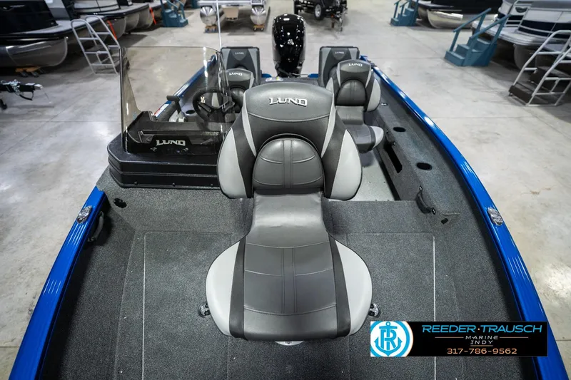 Slide: The Image of 2026 Lund 1675 Adventure SS boat interior with gray seating and steering console. - 17