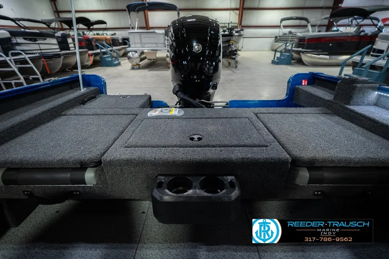 Slide: The Image of 2026 Lund 1675 Adventure SS boat interior with motor, showcased in a marine showroom. - 20