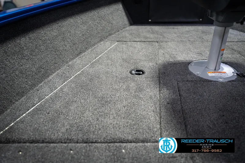 Slide: The Image of 2026 Lund 1675 Adventure SS boat interior with carpeted flooring and seat base. - 26