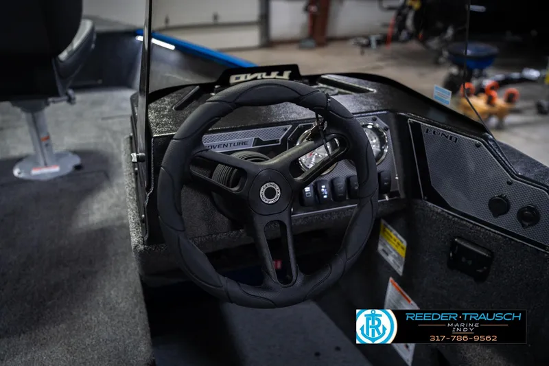 Slide: The Image of Steering wheel and dashboard of 2026 Lund 1675 Adventure SS boat in a showroom. - 29