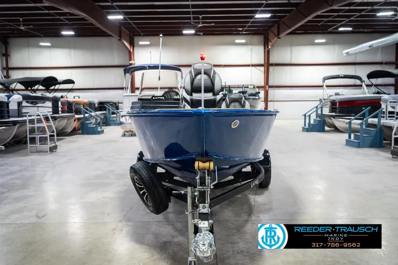 Slide: The Image of 2026 Lund 1675 Adventure SS boat in showroom, front view, on trailer. - 3