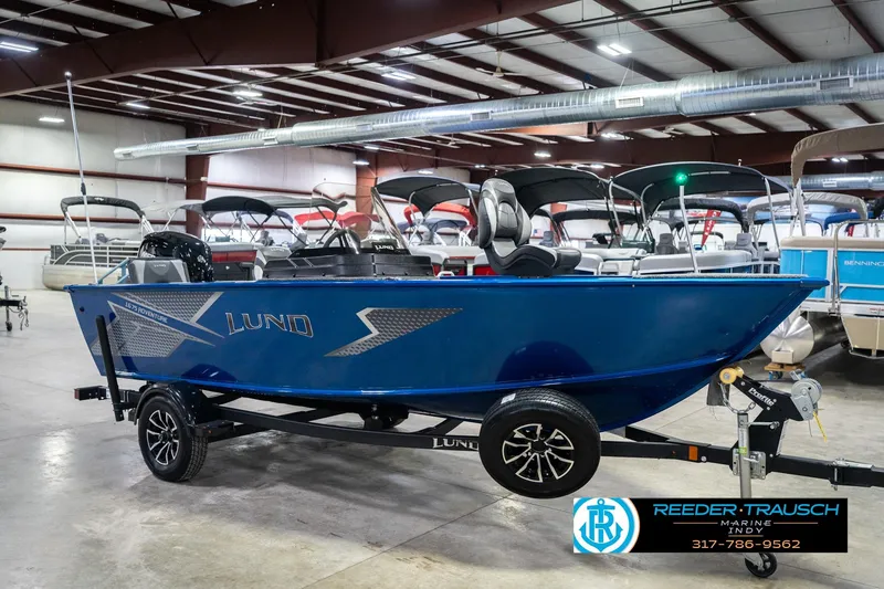 Slide: The Image of 2026 Lund 1675 Adventure SS boat in showroom, blue exterior, on trailer. - 4