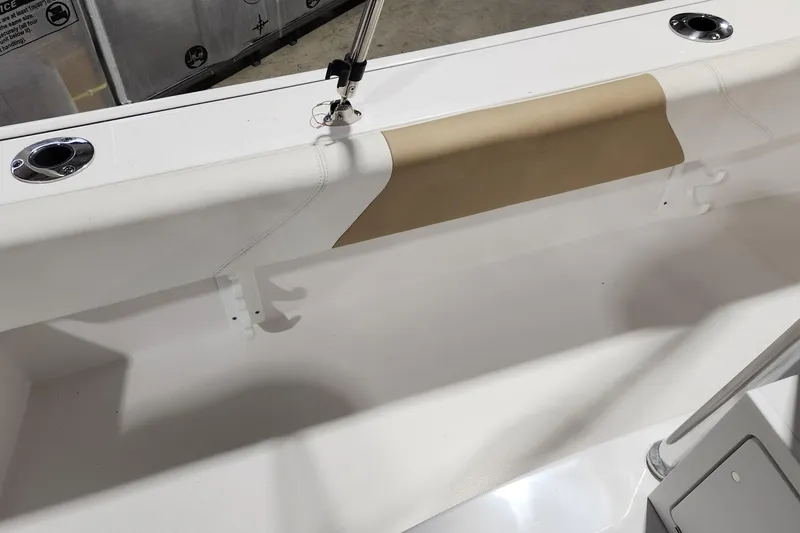 Slide: The Image of 2024 Edgewater 188CC boat interior detail with rod holders and cushioned seating. - 7