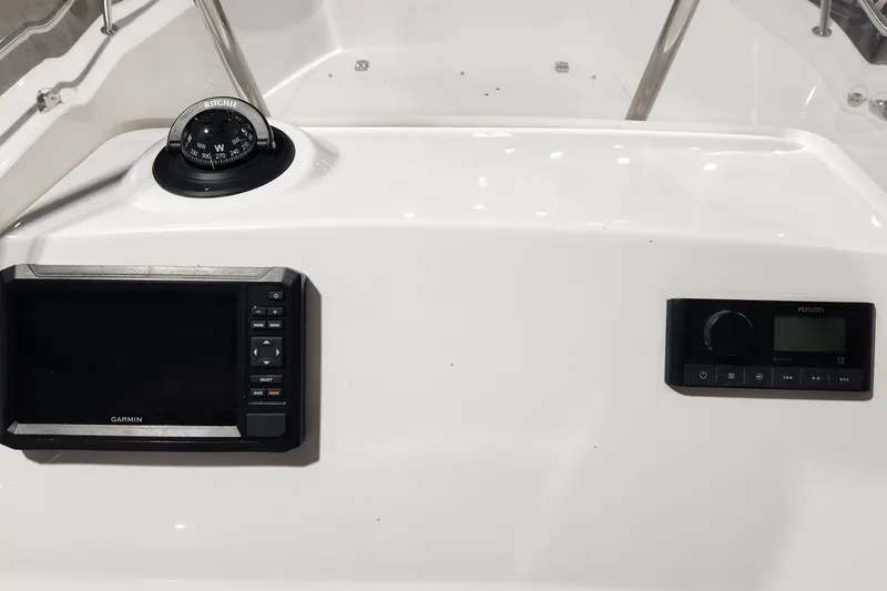 Slide: The Image of 2024 Edgewater 188CC boat dashboard with Garmin display and Ritchie compass. - 8