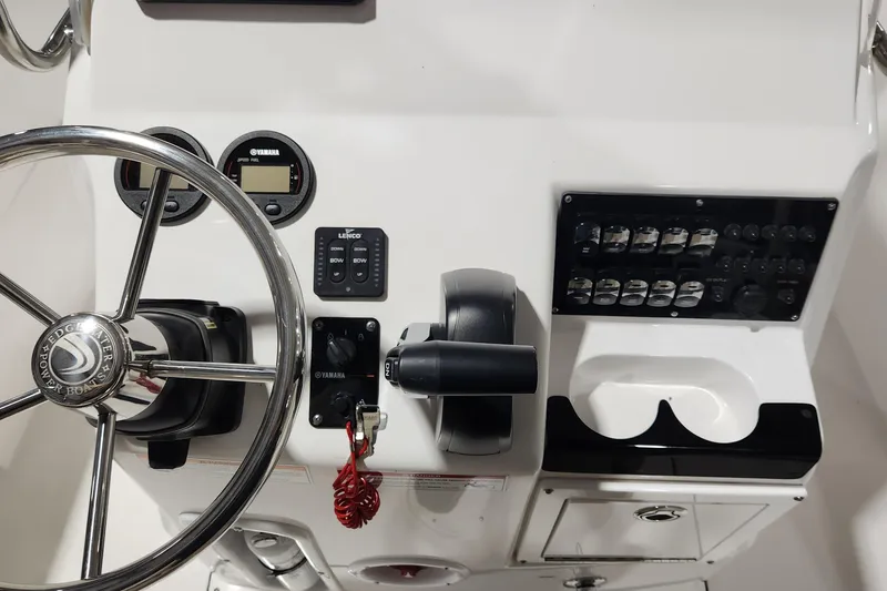 Slide: The Image of 2024 Edgewater 188CC boat dashboard with steering wheel, controls, and instrument panel. - 9