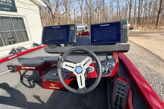 Slide: The Image of 2022 Vexus AVX1980 boat dashboard with dual navigation screens and steering wheel. - 5