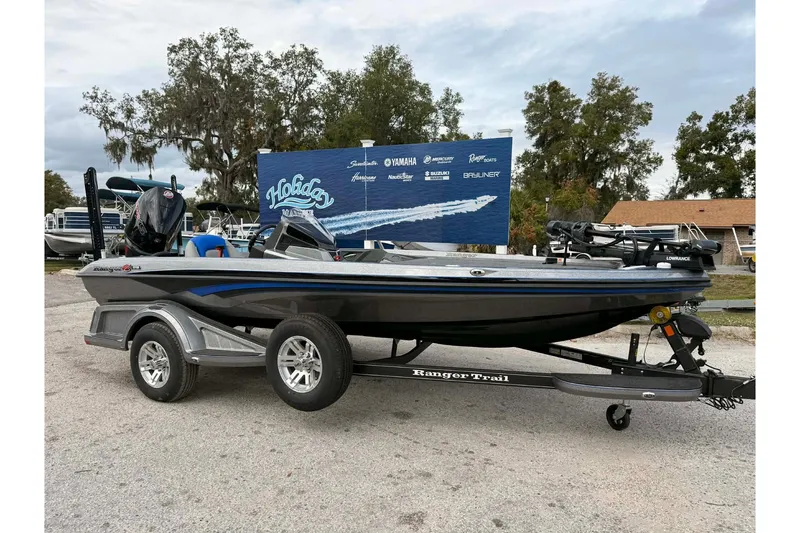 The Image of 2026 Ranger Z518 boat on trailer, displayed outdoors with promotional backdrop. - 0