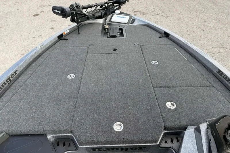 Slide: The Image of 2026 Ranger Z518 boat deck with carpeted surface and Lowrance equipment. - 7