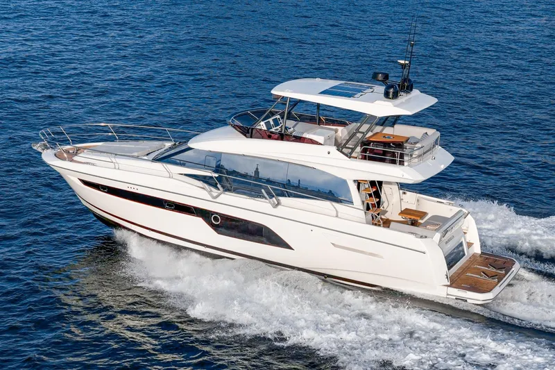 Slide: The Image of 2023 Prestige 520 yacht cruising on open water, showcasing sleek design and luxury features. - 11