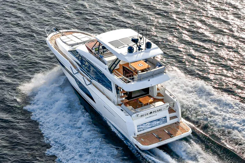 Slide: The Image of 2023 Prestige 520 yacht cruising on open water, rear view. - 19