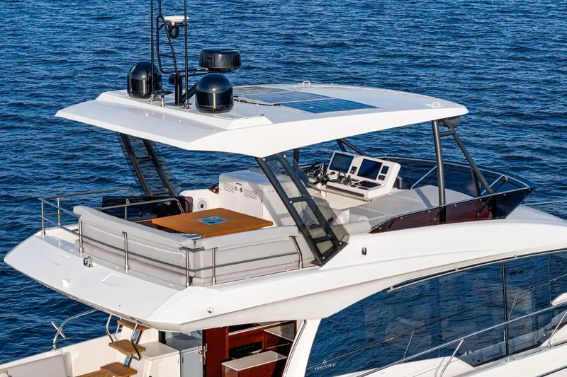 Slide: The Image of 2023 Prestige 520 yacht with modern flybridge and navigation equipment on open sea. - 27
