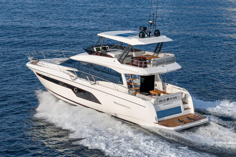 Slide: The Image of 2023 Prestige 520 yacht cruising on open water, showcasing sleek design and luxury features. - 3