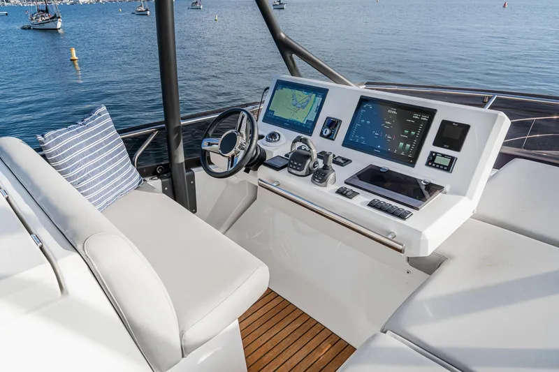 Slide: The Image of Helm station of 2023 Prestige 520 yacht with modern navigation equipment and comfortable seating. - 30