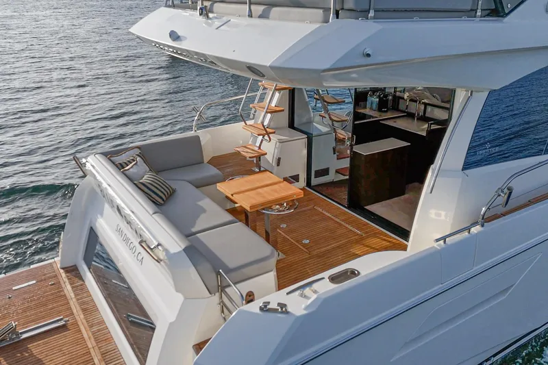 Slide: The Image of 2023 Prestige 520 yacht with elegant deck and seating area on the water. - 34