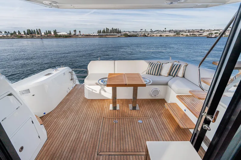 Slide: The Image of Luxurious 2023 Prestige 520 yacht deck with seating, wooden flooring, and ocean view. - 35