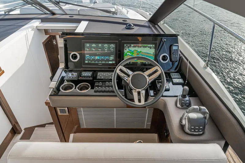 Slide: The Image of 2023 Prestige 520 yacht helm with advanced navigation and control systems. - 48
