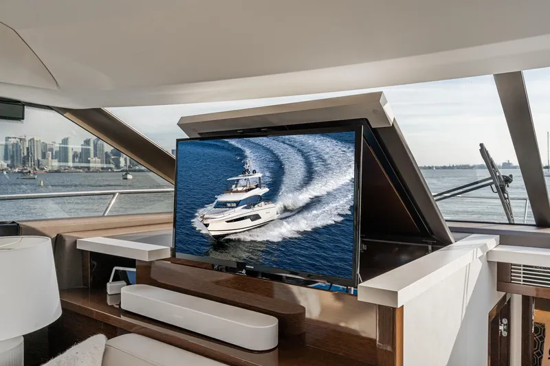 Slide: The Image of Luxurious 2023 Prestige 520 yacht interior with retractable TV and scenic ocean view. - 49