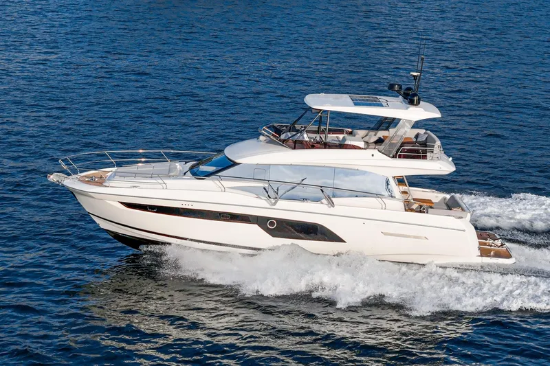 Slide: The Image of 2023 Prestige 520 yacht cruising on open water, showcasing sleek design and luxury features. - 5