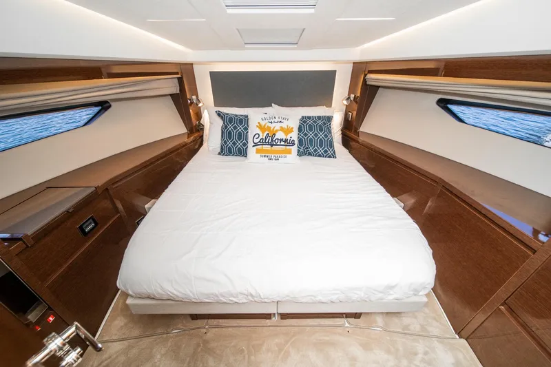 Slide: The Image of Luxurious bedroom interior of 2023 Prestige 520 yacht with elegant bedding and wood finishes. - 50