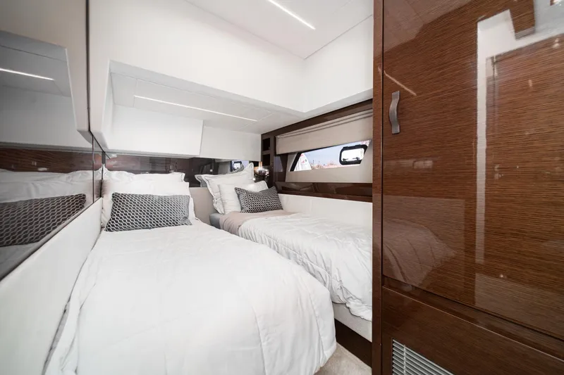 Slide: The Image of Luxurious 2023 Prestige 520 yacht cabin with twin beds and elegant wood finishes. - 53